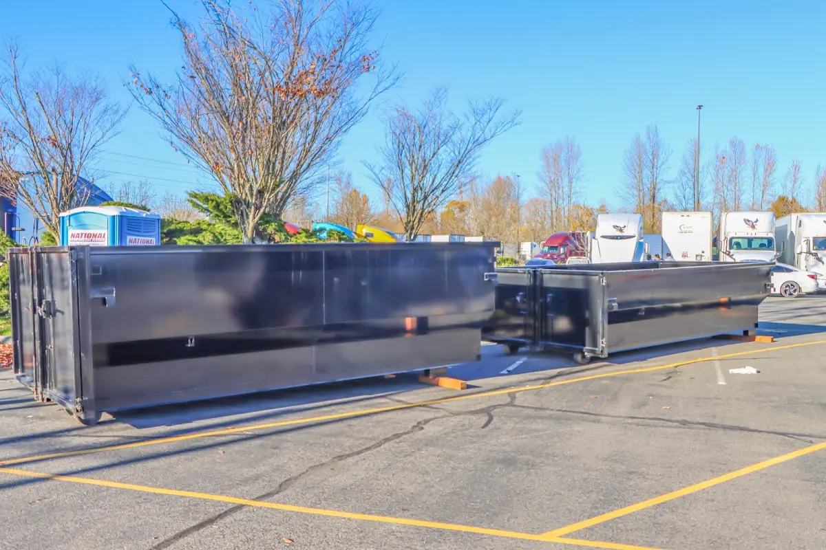 Professional dumpster rental service with roll-off container on residential driveway in Mexico